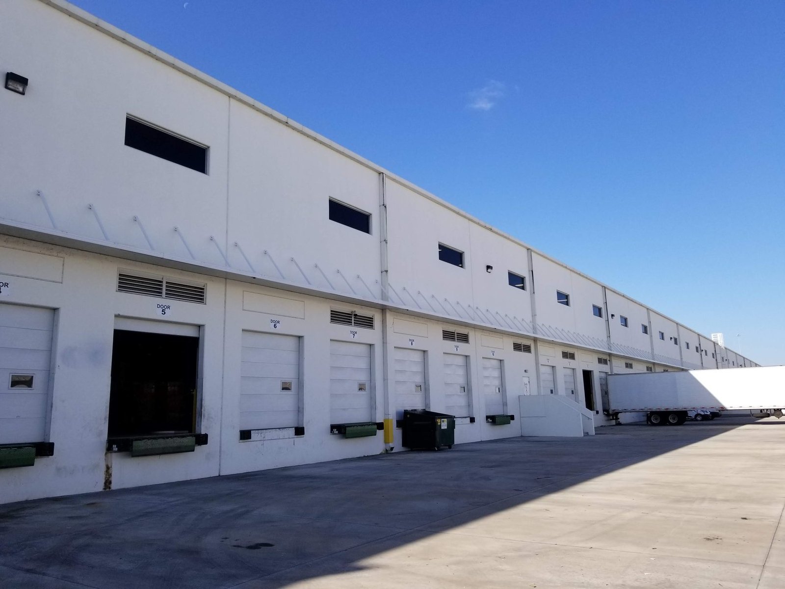Row of numbered dock doors along the Miami warehouse